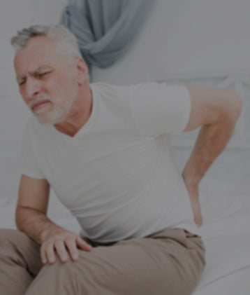 Man with back pain considering CBD and THC for relief.
